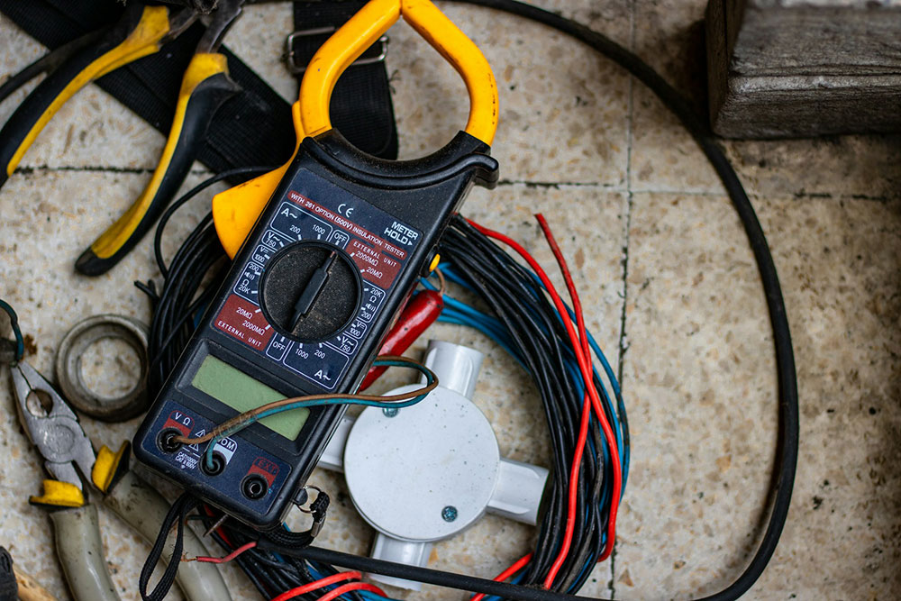 An electricians black and yellow clamp meter